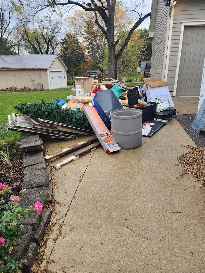 Dumpster being loaded with debris for 10 Yard Dumpster Rental in Waupaca